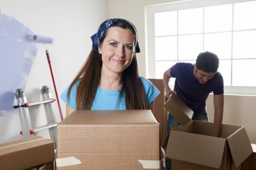 Packed boxes and furniture ready for loading into a moving van