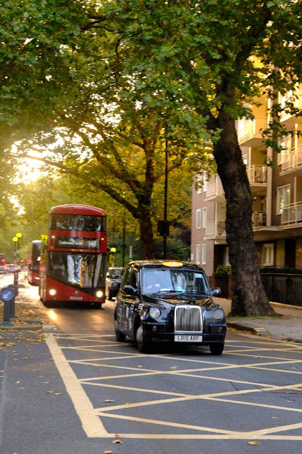 A burgundy flatbed van parked on a street in Rotherhithe, loaded with several large white and grey plastic-wrapped packages, some covered with black plastic bags. The vehicle is positioned near a mode